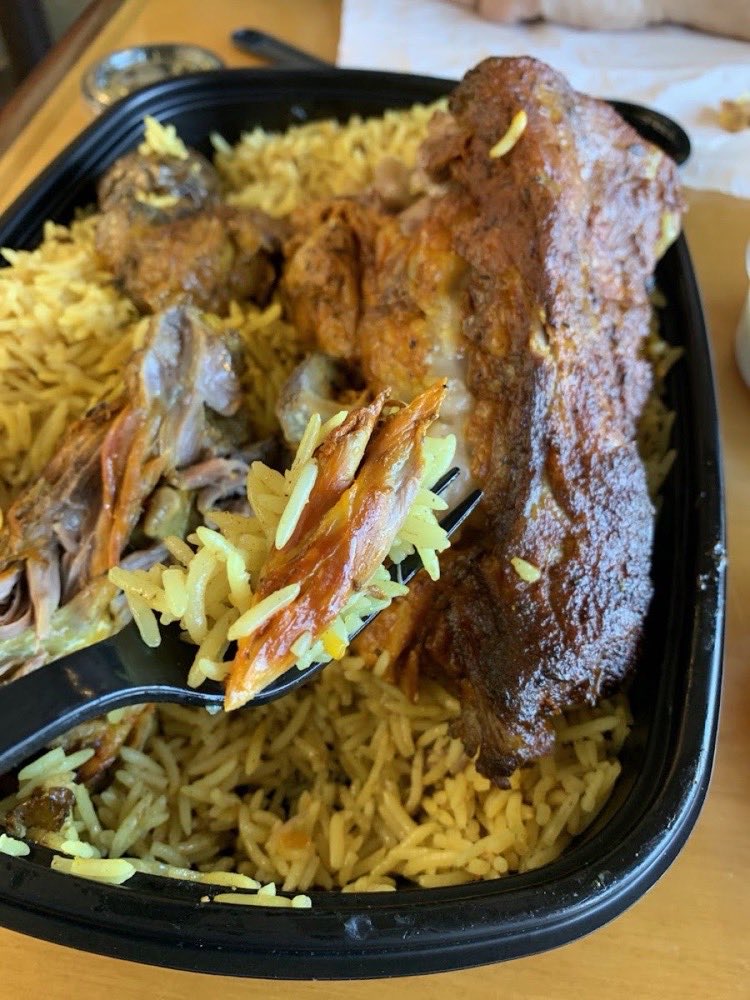 Roasted lamb with slivered almonds over rice.